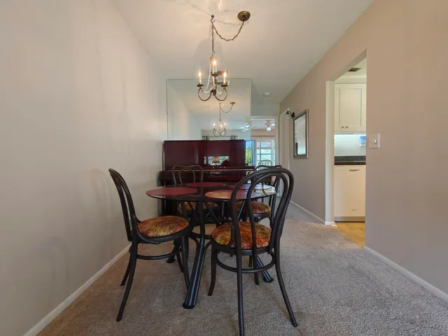 a view of a dining room with furniture and chandelier