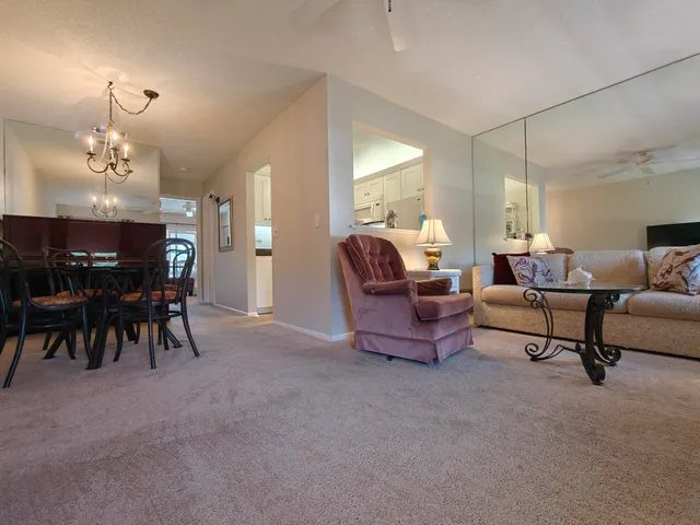 a living room with furniture a dining table and a piano