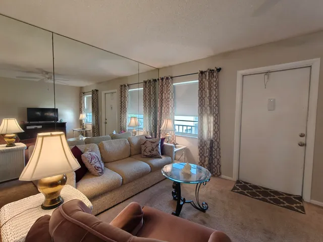 a living room with furniture and a lamp
