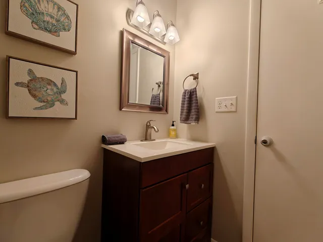 a bathroom with a toilet a sink and mirror
