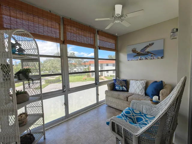 a living room with furniture and a floor to ceiling window