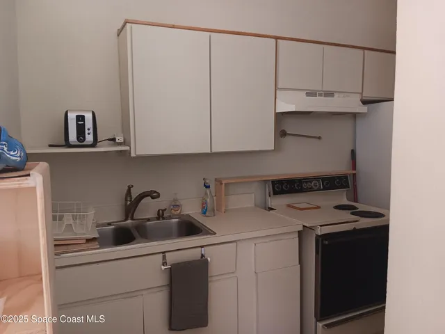 a kitchen with stainless steel appliances granite countertop a sink a stove and cabinets