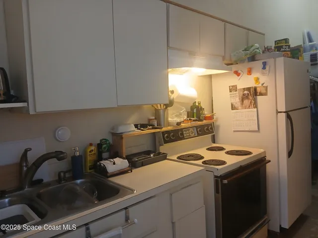 a kitchen with a refrigerator sink and stove