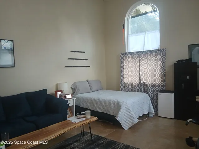 a bedroom with a bed and window