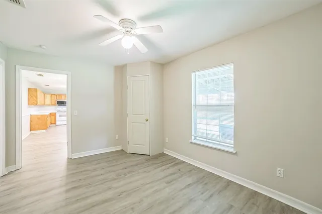 wooden floor in an empty room with a window