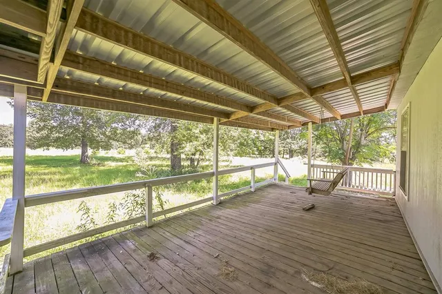 a view of porch with wooden floor