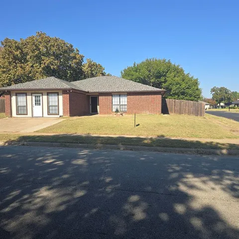 a view of a house next to a big yard