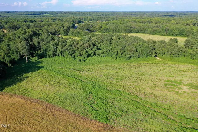 a view of a field of grass and a lake view