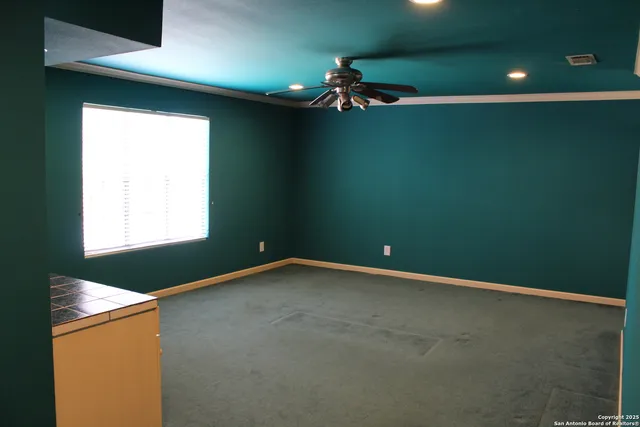 a view of a hallway with a livingroom and furniture