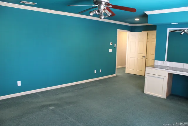 a bathroom with a toilet a sink a window and cabinets