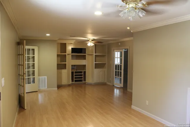 a view of a livingroom with furniture and chandelier fan