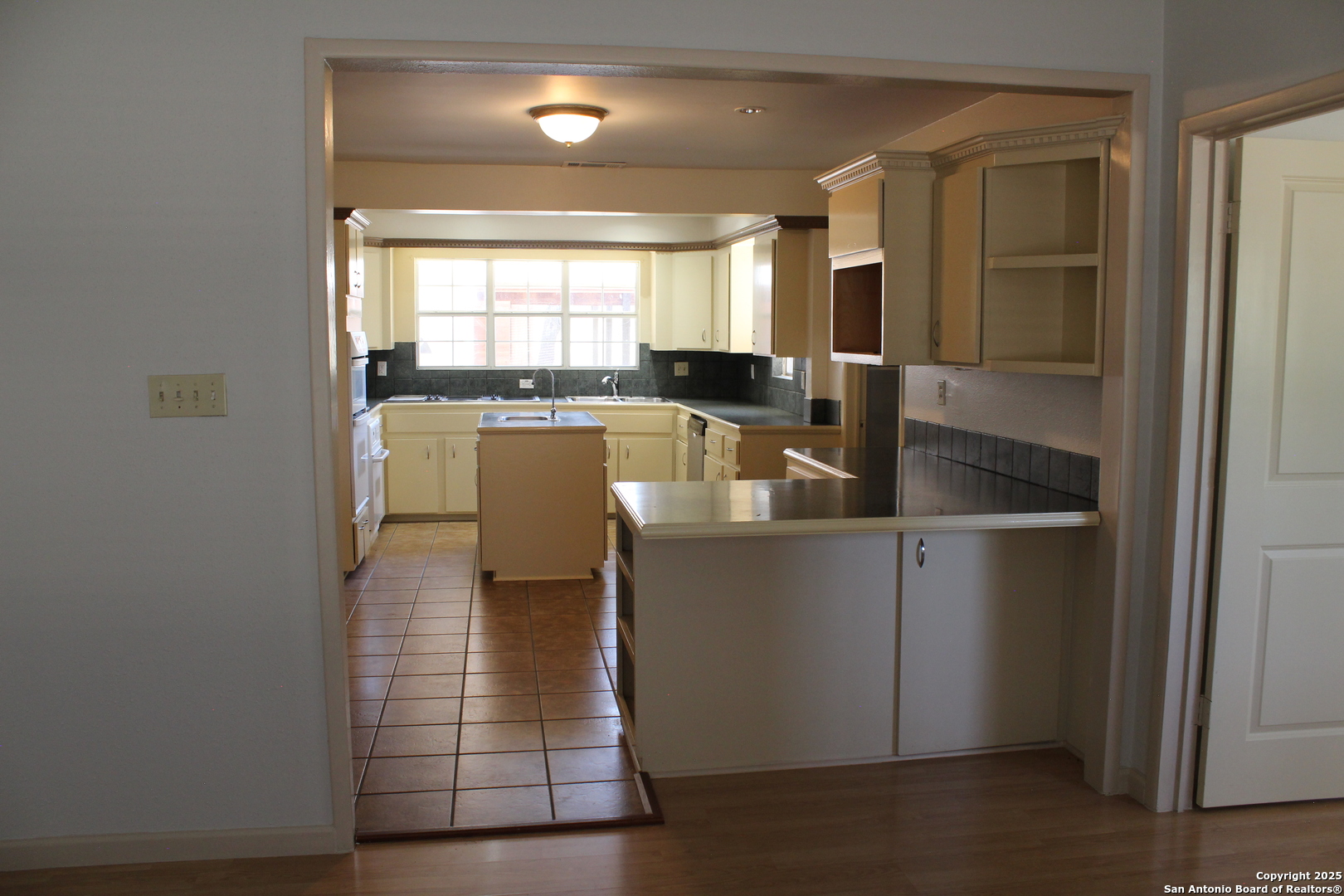 24590 Trumbo Road San Antonio, TX 78264 - Photo 30 of 34 a kitchen with a sink cabinets and wooden floor