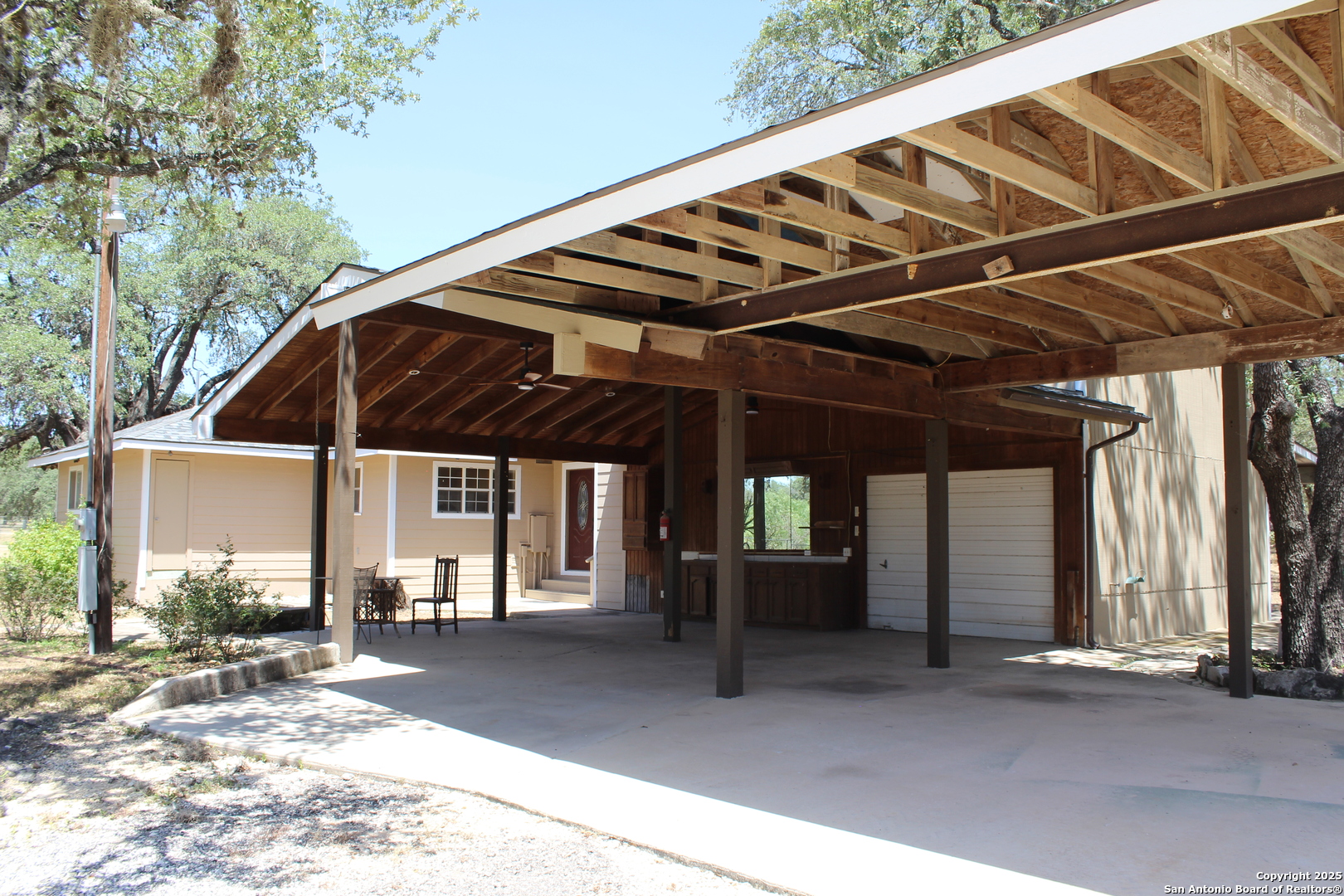 24590 Trumbo Road San Antonio, TX 78264 - Photo 34 of 34 a view of porch with a table and chairs under an umbrella