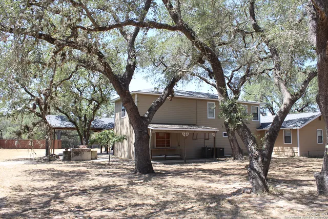 a view of a trees and tree in front of a house