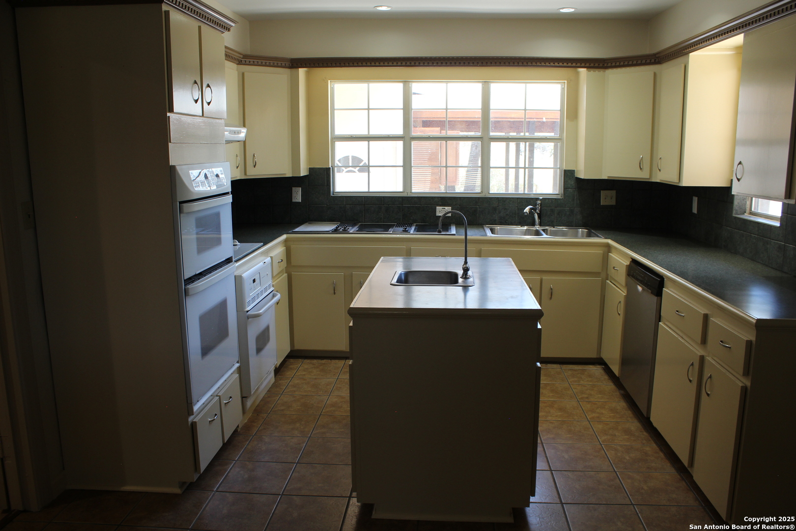 24590 Trumbo Road San Antonio, TX 78264 - Photo 9 of 34 a kitchen that has a sink and a stove in it