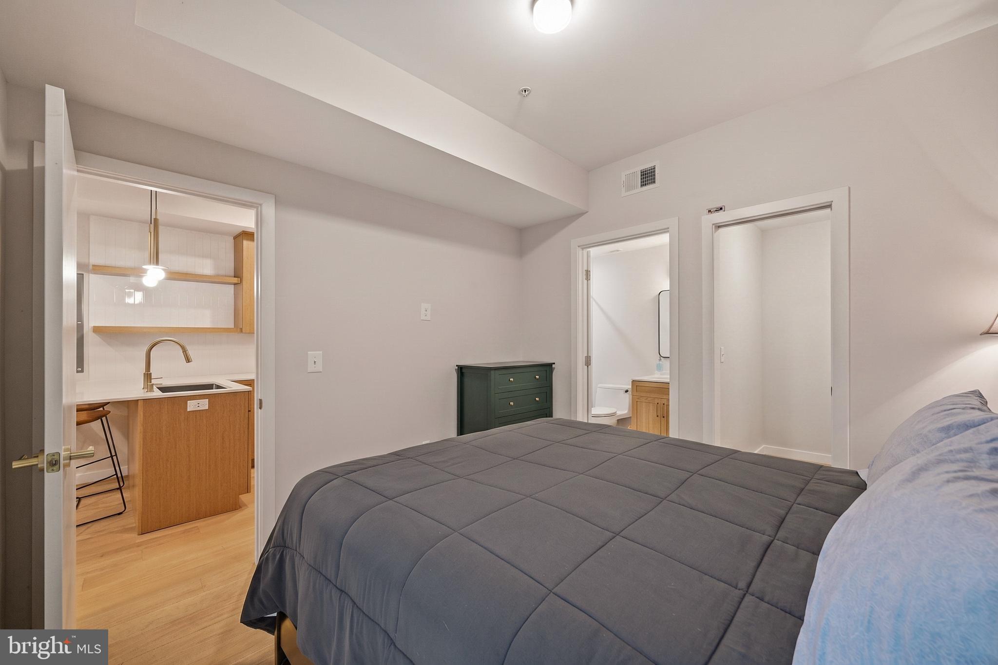 1402 12th Street Northwest, Unit 3 Washington, DC 20005 - Photo 18 of 23 a bedroom with a bed and cabinet