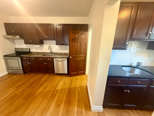 a kitchen with wooden cabinets and a sink