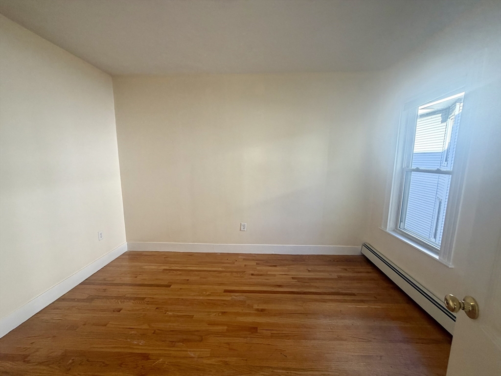 19 Banks Street, Unit 1 Somerville, MA 02144 - Photo 14 of 16 a view of an empty room and window