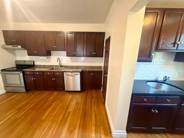 a kitchen with wooden cabinets and sink