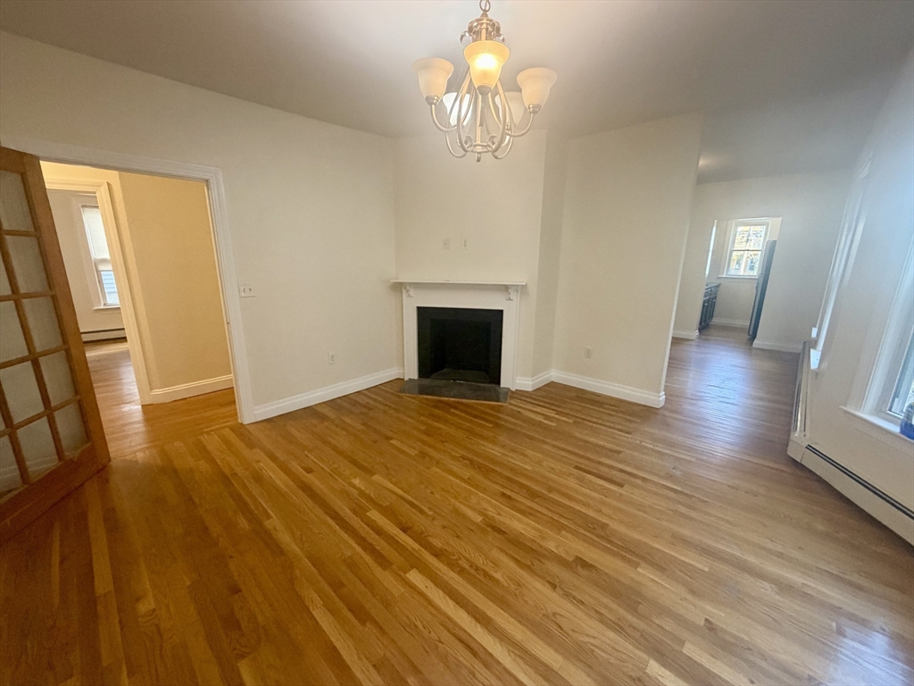 19 Banks Street, Unit 1 Somerville, MA 02144 - Photo 5 of 16 a view of empty room with wooden floor