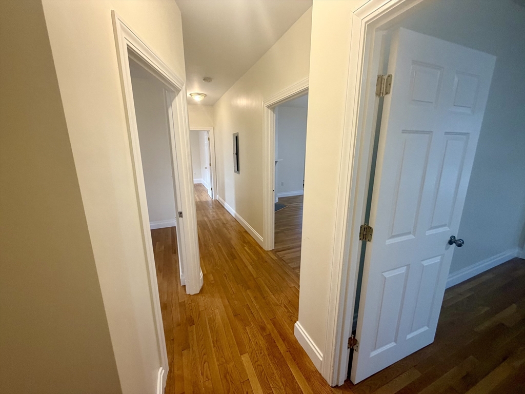 19 Banks Street, Unit 1 Somerville, MA 02144 - Photo 6 of 16 a view of a hallway with wooden floor and staircase
