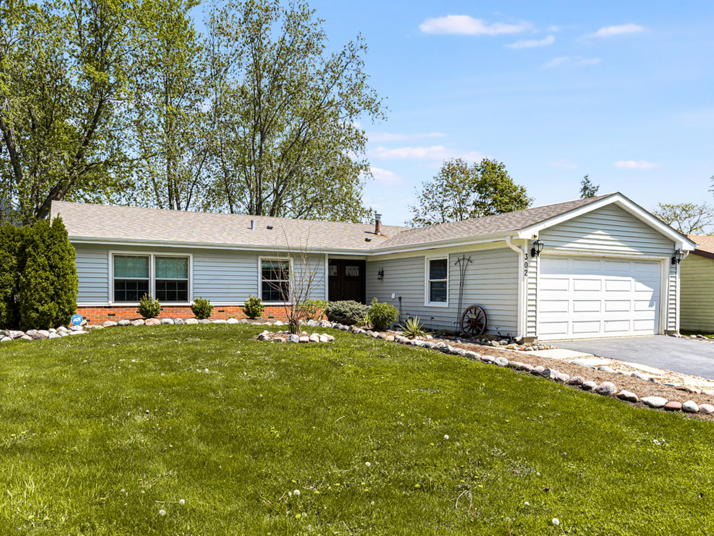 a view of a house with a patio and a garden
