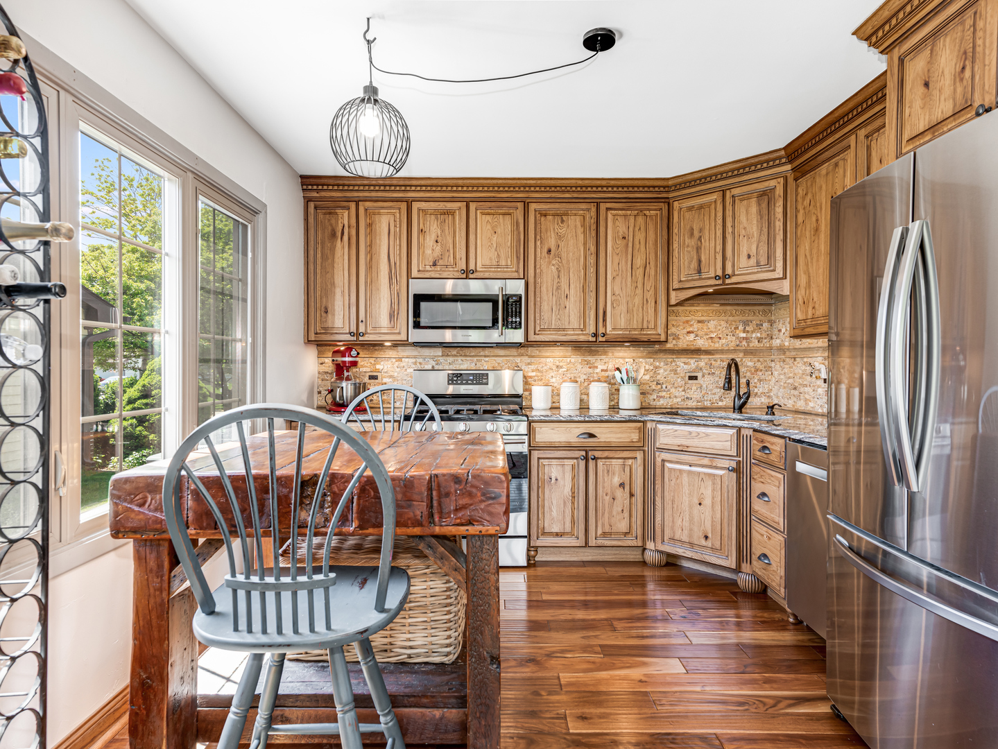 302 Delaware Drive Bolingbrook, IL 60440 - Photo 6 of 21 a kitchen with stainless steel appliances granite countertop a stove a sink dishwasher a refrigerator with a dining table and chairs with wooden floor