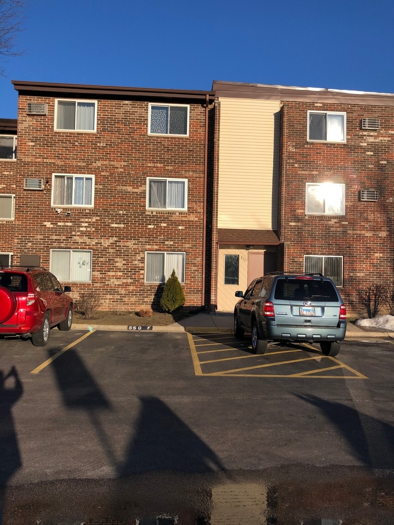 550 Pleasant Run Drive Wheeling, IL 60090 - Photo 6 of 7 a car parked in front of a building