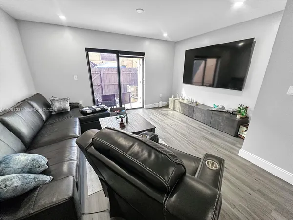 a living room with furniture fireplace and a flat screen tv