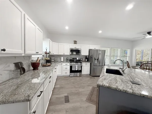 a large kitchen with granite countertop lots of counter top space