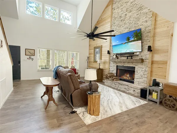 a living room with furniture a fireplace and a flat screen tv
