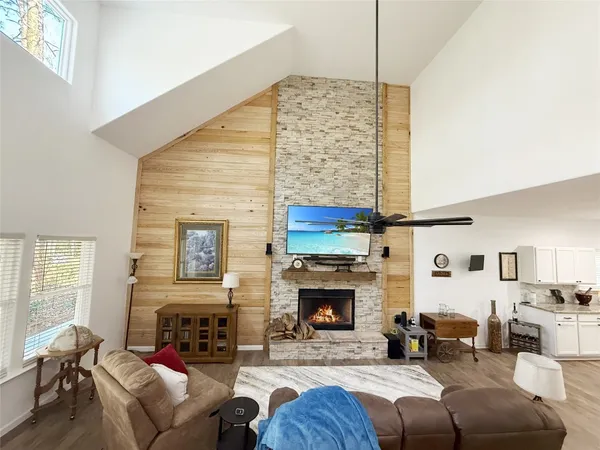a living room with furniture a fireplace and a flat screen tv