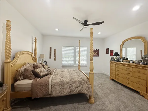 a bed room with a bed and a dresser