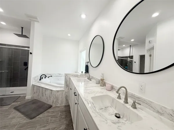 a bathroom with 2 sink and a mirror