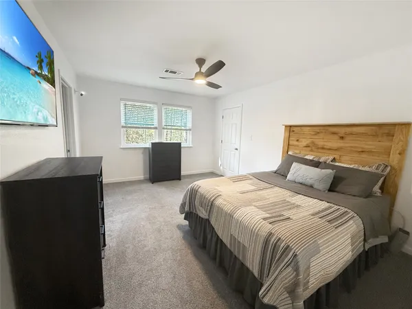 a bedroom with a large bed and a window