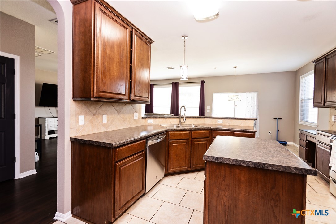612 Pumpkin Drive Temple, TX 76502 - Photo 11 of 33 a kitchen with stainless steel appliances granite countertop a sink stove and cabinets