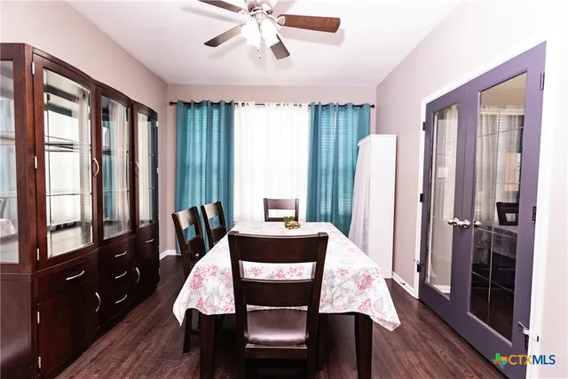 a bedroom with a bed and a tv on the dresser