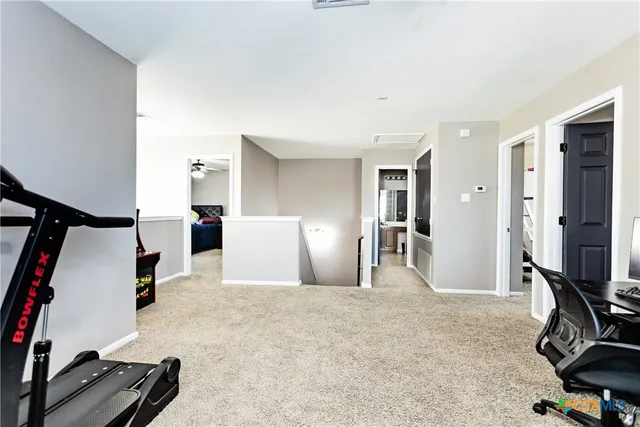 a view of a bedroom with furniture and a ceiling fan