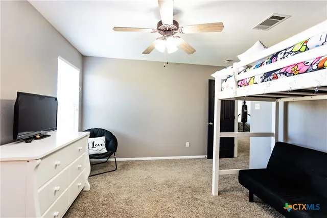 a view of a big room with wooden floor windows and cabinet