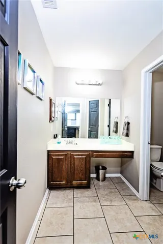 a street view of a house with snow on the road