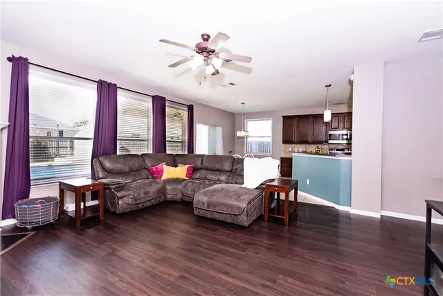 a kitchen with granite countertop wooden cabinets stainless steel appliances and a sink