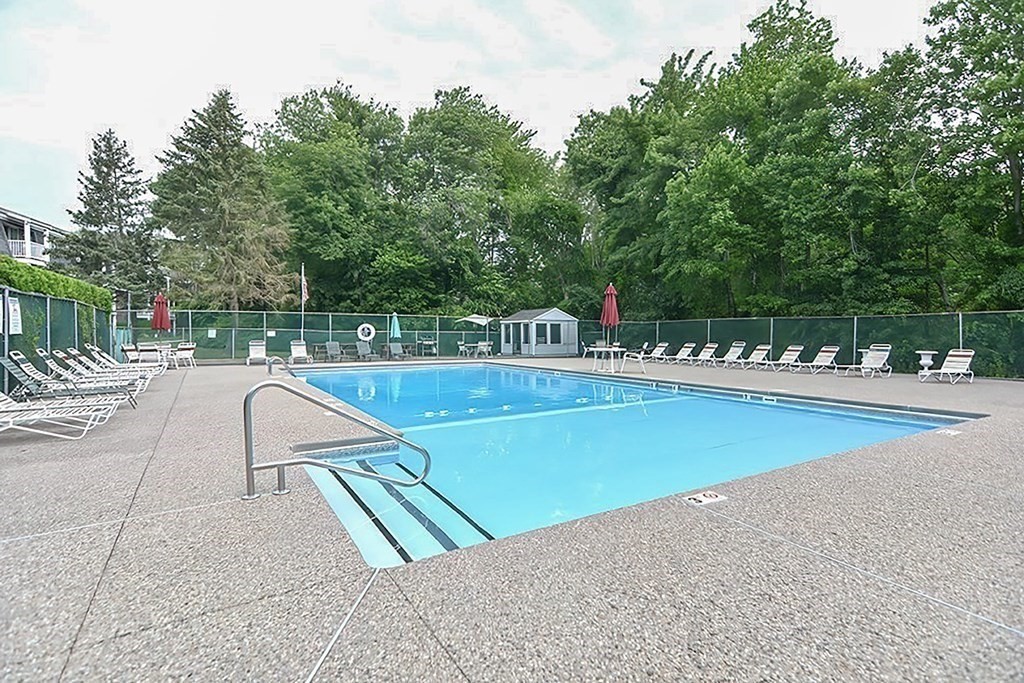 57 Will Drive, Unit 170 Canton, MA 02021 - Photo 13 of 15 a view of a swimming pool with a lawn chairs