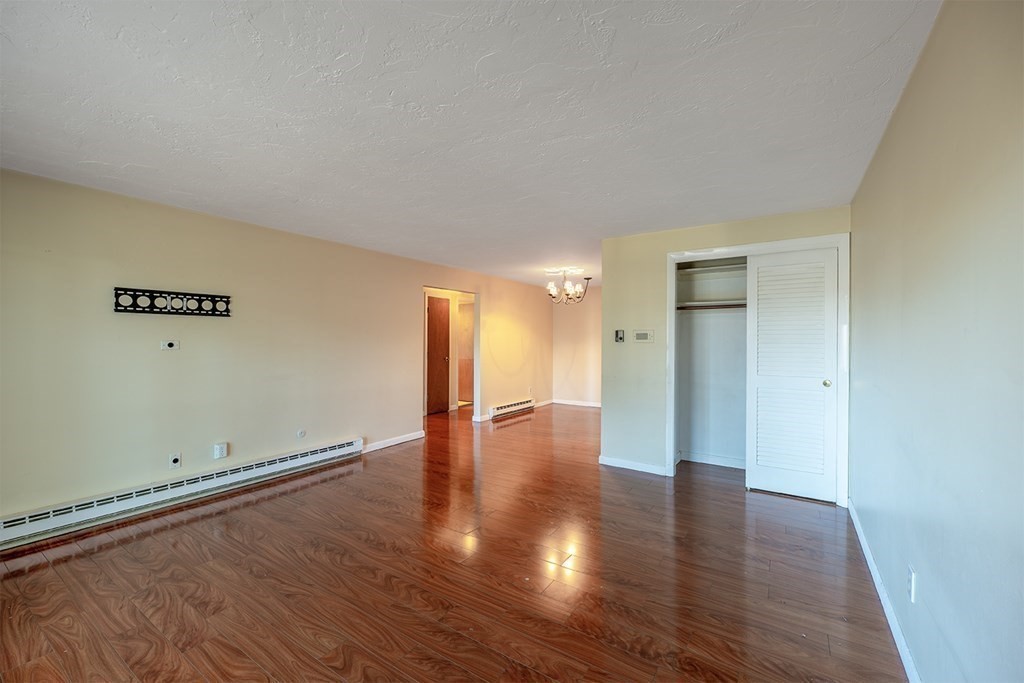 57 Will Drive, Unit 170 Canton, MA 02021 - Photo 2 of 15 a view of empty room with wooden floor