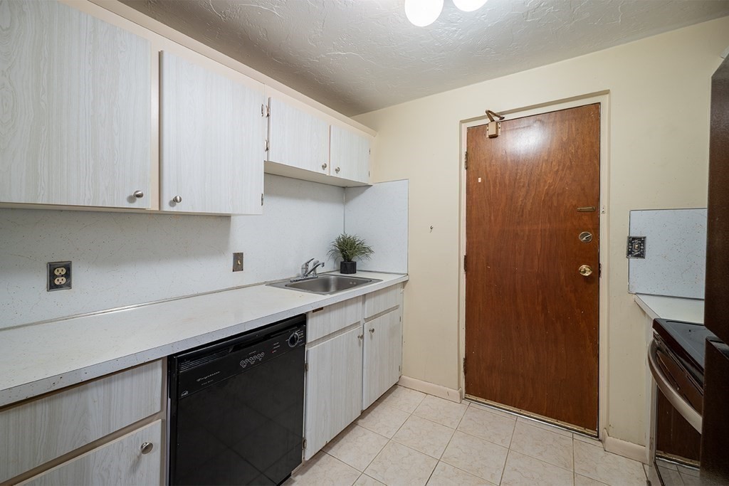 57 Will Drive, Unit 170 Canton, MA 02021 - Photo 6 of 15 a kitchen with a sink and cabinets