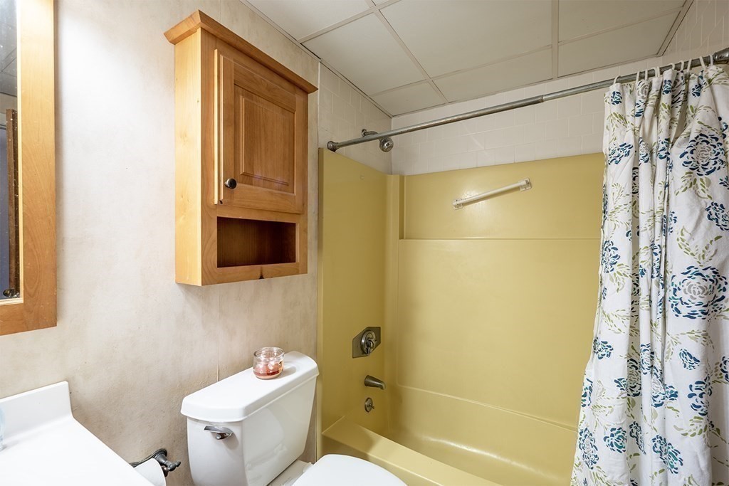 57 Will Drive, Unit 170 Canton, MA 02021 - Photo 10 of 15 a bathroom with a sink a toilet and shower