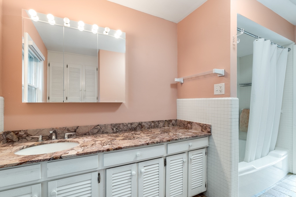 140 Paulson Road Newton, MA 02468 - Photo 15 of 23 a bathroom with a granite countertop sink and a mirror