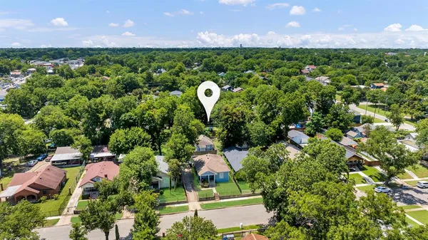a aerial view of a house with a yard and garden