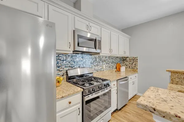a kitchen with a stove and a microwave