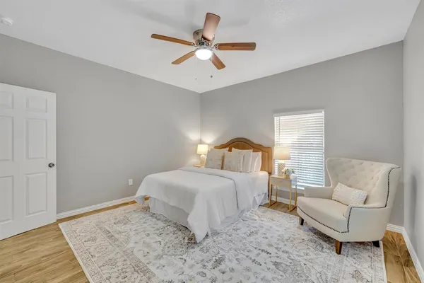 a bedroom with a bed couches and window