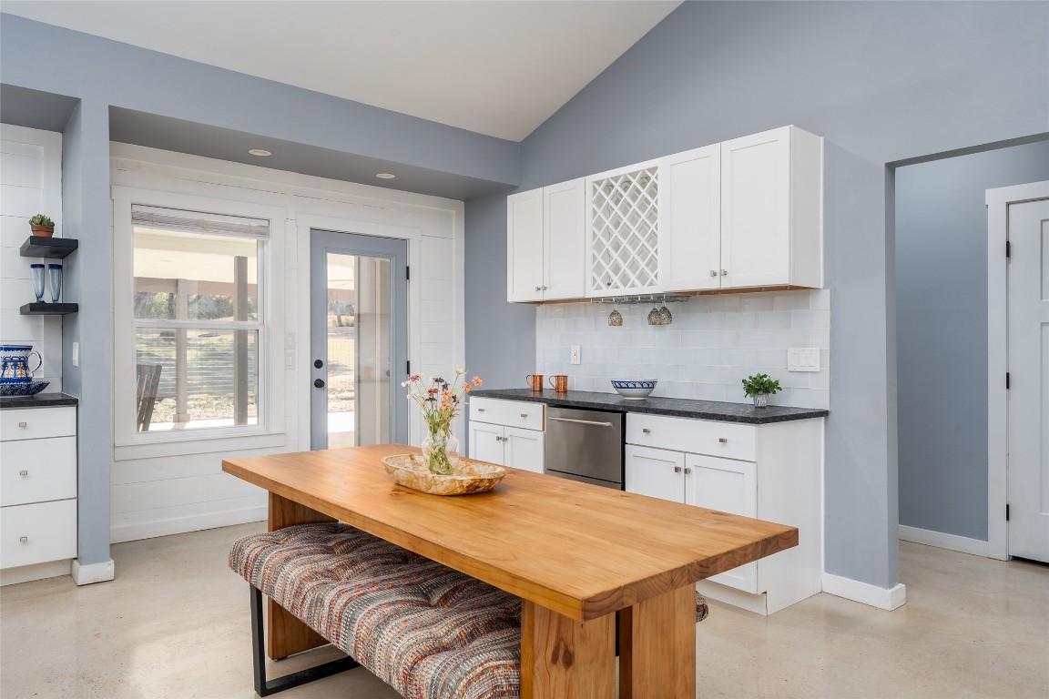 33 Deer Ridge Road Wimberley, TX 78676 - Photo 11 of 40 a kitchen with stainless steel appliances granite countertop a stove a sink dishwasher and a refrigerator with wooden cabinets